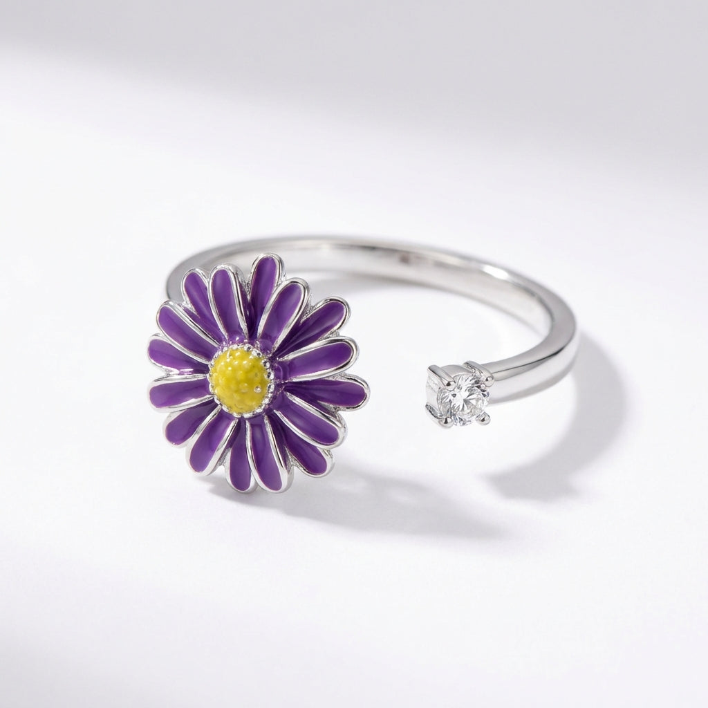 VÉYNOMA Eden Ring aus 925er Silber mit drehbarem lila Gänseblümchen-Motiv und Zirkonia Stein, verstellbare Größe.