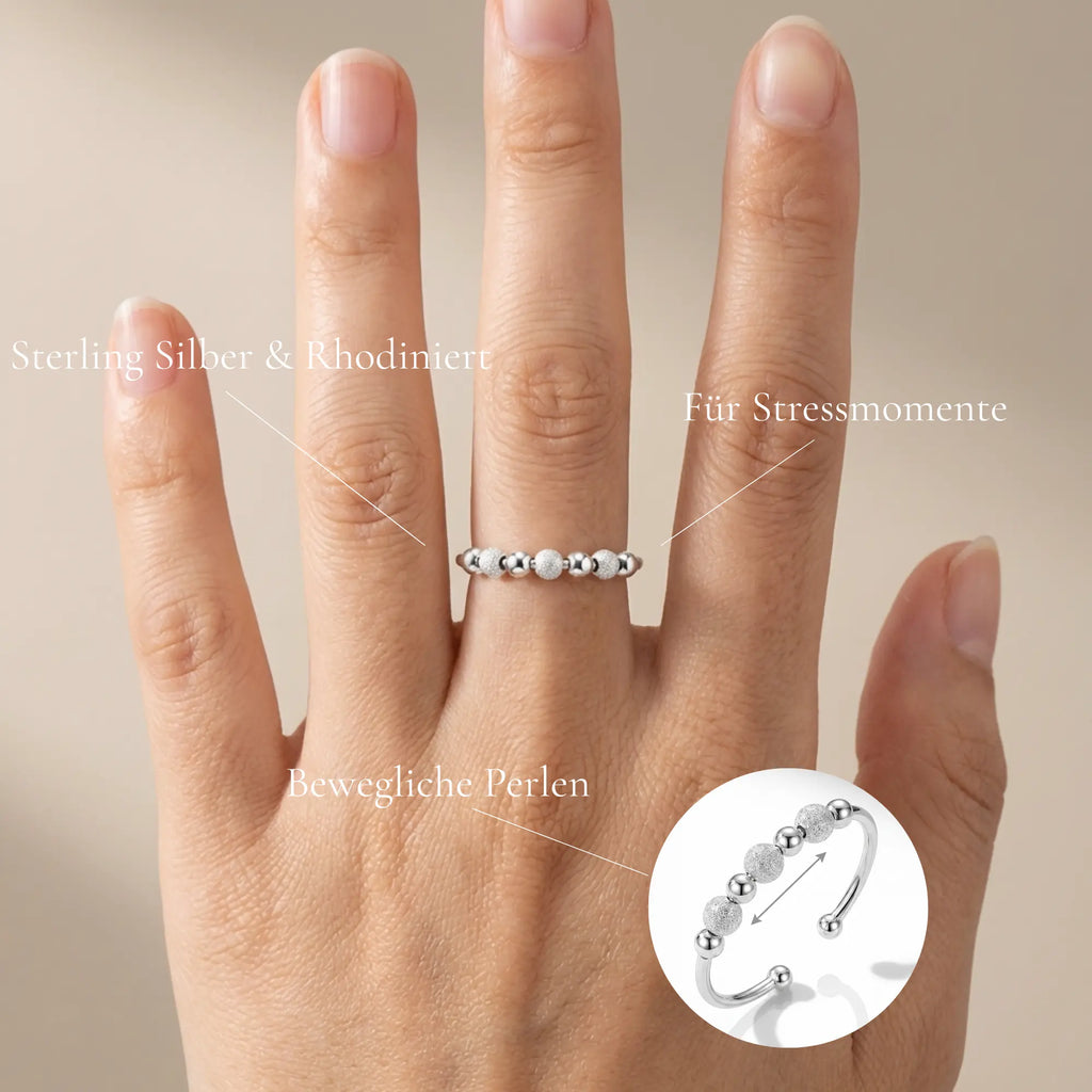 Infografik Nivia: Erklärt die haptische Beruhigung durch verschiebbare Perlen, Sterling Silber Material und Rhodinierung für Langlebigkeit.